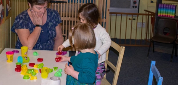 Sunday School activity with two children accompanied by adult.