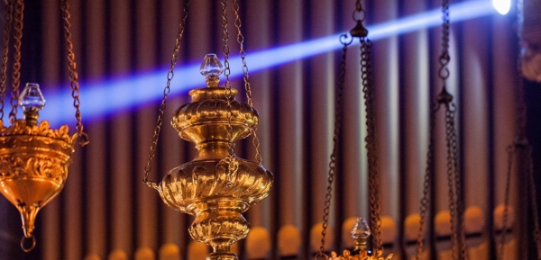 Close up of chancel sanctuary lamps hanging by organ.