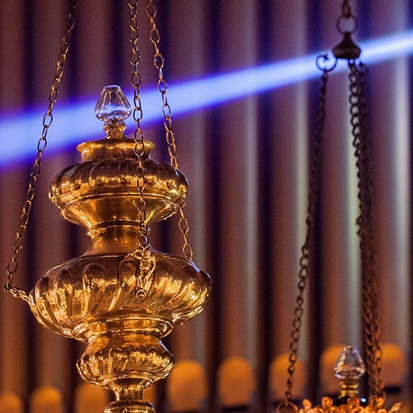 Close up of chancel sanctuary lamps hanging by organ.