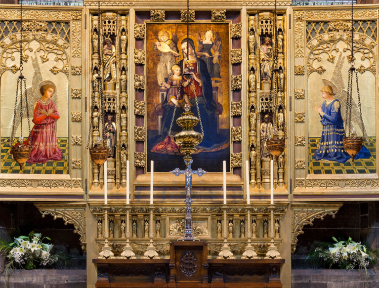 Reredos (triptych screen behind altar) designed by Hay & Henderson and featuring a copy of Virgin and Child with Saints by Benvenuto di Giovanni, with candles for mass.